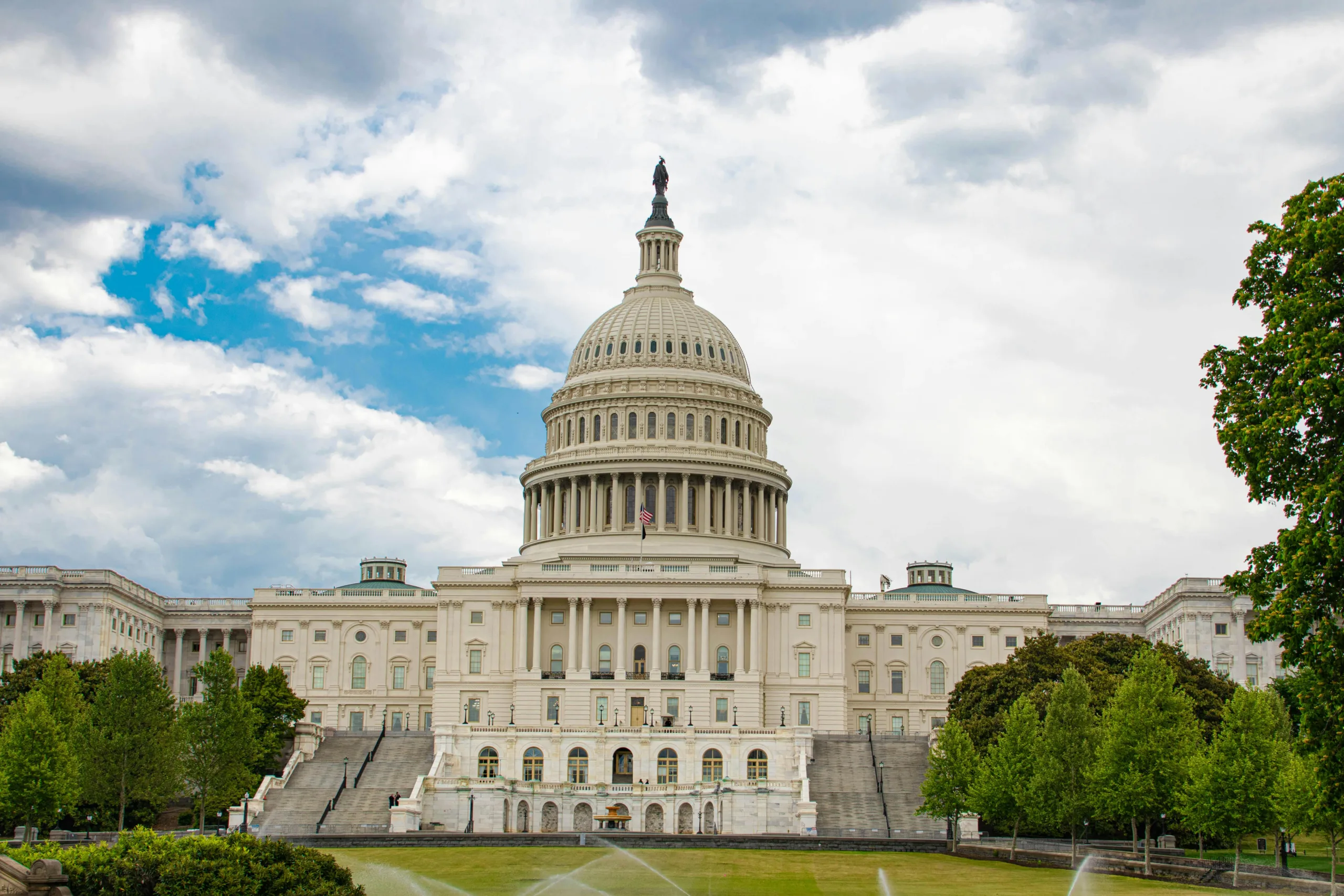 A Capitol Building Under the White Clouds and Blue Sky